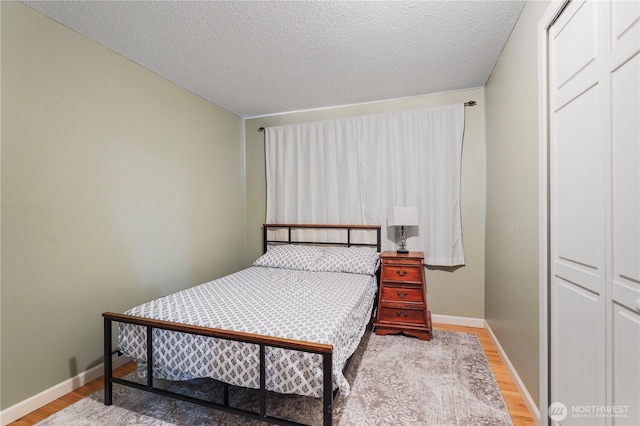 2120 Seaview St W, University Place, WA 98466 - bedroom with wood finished floors and a textured ceiling