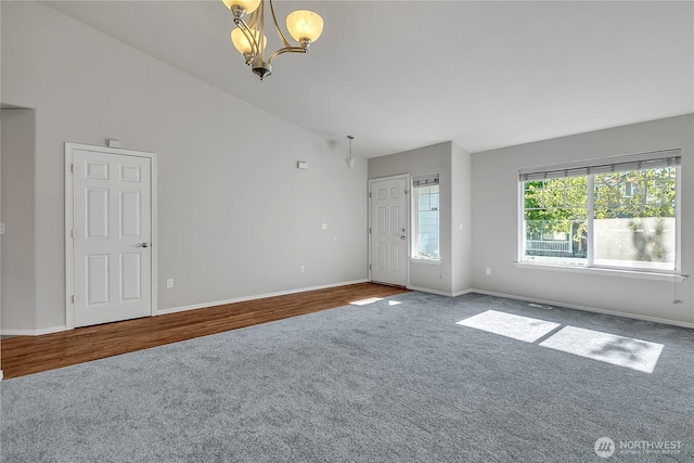 18619 16th Avenue Ct E, Spanaway, WA 98387 - carpeted empty room with a chandelier and vaulted ceiling