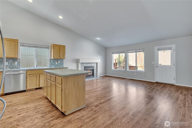 18619 16th Avenue Ct E, Spanaway, WA 98387 - kitchen featuring dishwasher, light brown cabinetry, tasteful backsplash, open floor plan, and a tile fireplace