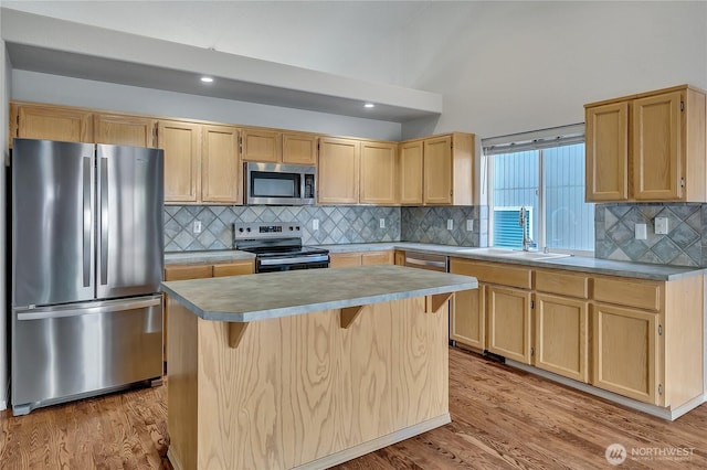 18619 16th Avenue Ct E, Spanaway, WA 98387 - kitchen with appliances with stainless steel finishes, light brown cabinets, light wood-style floors, a kitchen island, and recessed lighting