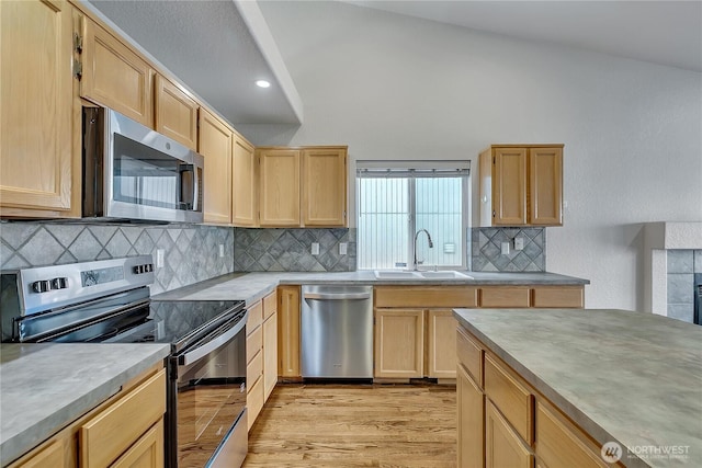 18619 16th Avenue Ct E, Spanaway, WA 98387 - kitchen featuring appliances with stainless steel finishes, light brown cabinetry, light wood-style floors, tasteful backsplash, and recessed lighting