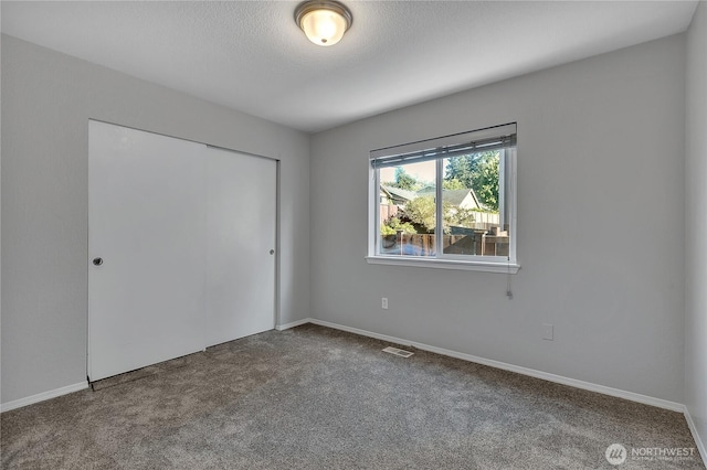 18619 16th Avenue Ct E, Spanaway, WA 98387 - unfurnished bedroom with carpet floors, a closet, and a textured ceiling