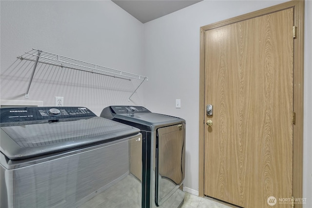 18619 16th Avenue Ct E, Spanaway, WA 98387 - laundry area featuring washing machine and clothes dryer and baseboards
