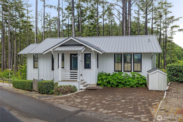 46 Seaside Ln, Pacific Beach, WA 98571 - view of front of home with board and batten siding, a metal roof, and a standing seam roof