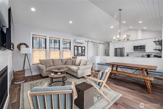 46 Seaside Ln, Pacific Beach, WA 98571 - living area featuring an AC wall unit, vaulted ceiling, a barn door, wood ceiling, and wood finished floors