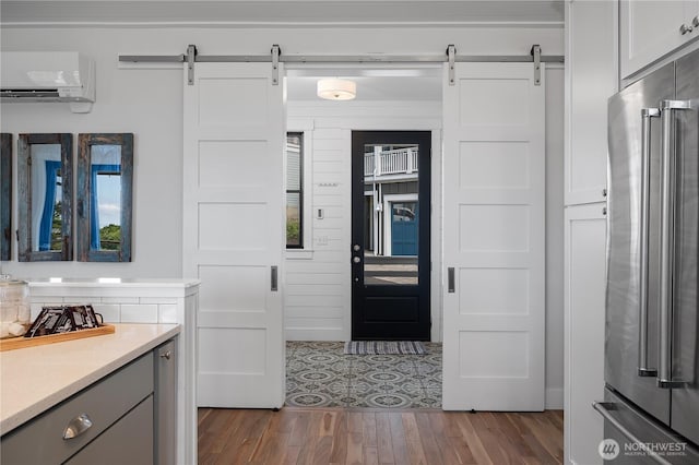 46 Seaside Ln, Pacific Beach, WA 98571 - kitchen featuring a barn door, high quality fridge, an AC wall unit, light countertops, and dark wood-type flooring