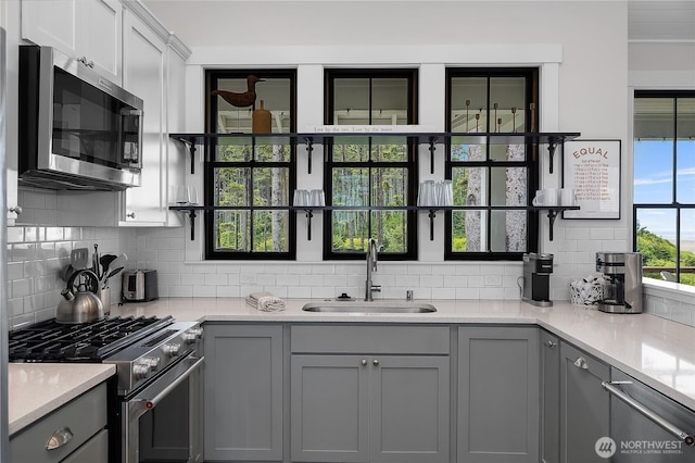 46 Seaside Ln, Pacific Beach, WA 98571 - kitchen with appliances with stainless steel finishes, gray cabinetry, and backsplash