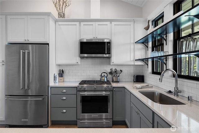 46 Seaside Ln, Pacific Beach, WA 98571 - kitchen with appliances with stainless steel finishes, open shelves, gray cabinetry, light stone countertops, and lofted ceiling