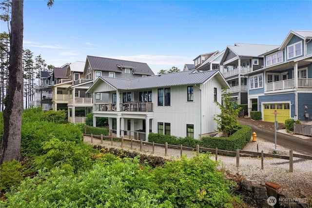 46 Seaside Ln, Pacific Beach, WA 98571 - back of property with a metal roof, a standing seam roof, board and batten siding, a residential view, and a balcony