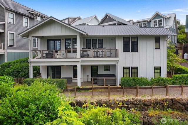46 Seaside Ln, Pacific Beach, WA 98571 - back of house featuring a balcony, board and batten siding, a metal roof, and a standing seam roof