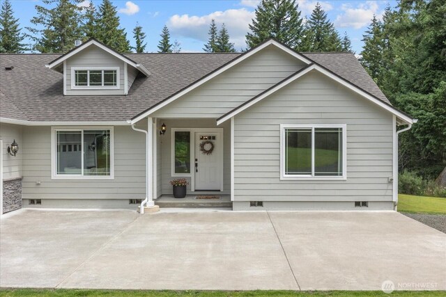 250 W Wynwood Dr, Shelton, WA 98584 - view of front of house with roof with shingles, crawl space, and a patio area