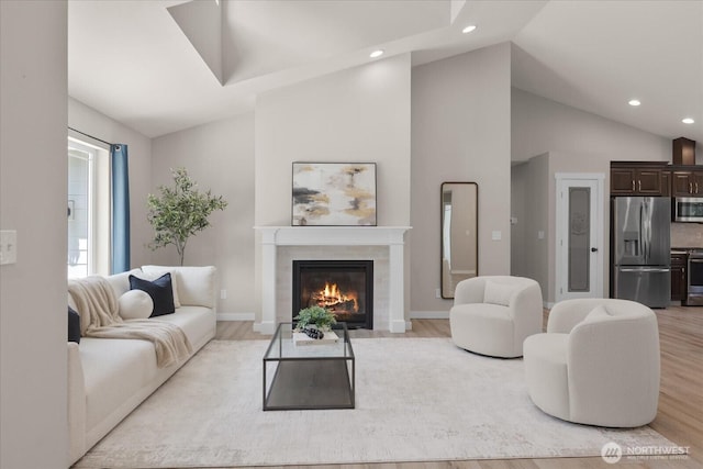 250 W Wynwood Dr, Shelton, WA 98584 - living area with light wood-type flooring, recessed lighting, a tile fireplace, and high vaulted ceiling