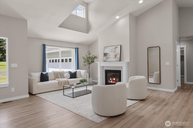 250 W Wynwood Dr, Shelton, WA 98584 - living area with high vaulted ceiling, light wood-type flooring, plenty of natural light, a glass covered fireplace, and recessed lighting