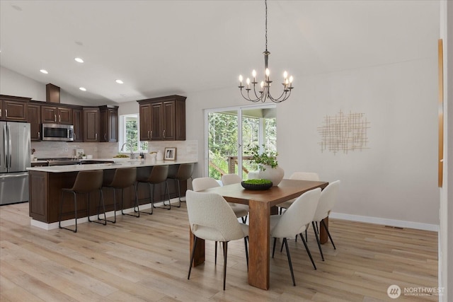250 W Wynwood Dr, Shelton, WA 98584 - dining space with a chandelier, lofted ceiling, light wood finished floors, and recessed lighting