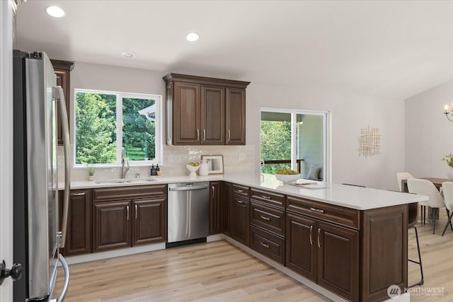 250 W Wynwood Dr, Shelton, WA 98584 - kitchen with appliances with stainless steel finishes, a peninsula, light countertops, plenty of natural light, and recessed lighting