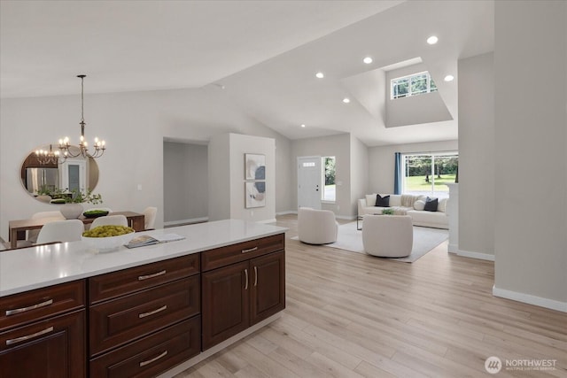 250 W Wynwood Dr, Shelton, WA 98584 - kitchen featuring vaulted ceiling, light countertops, light wood finished floors, a chandelier, and open floor plan