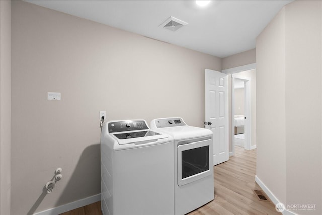 250 W Wynwood Dr, Shelton, WA 98584 - laundry room with washing machine and clothes dryer and light wood-type flooring