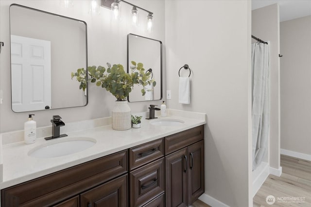 250 W Wynwood Dr, Shelton, WA 98584 - bathroom with double vanity, a shower with curtain, and wood finished floors