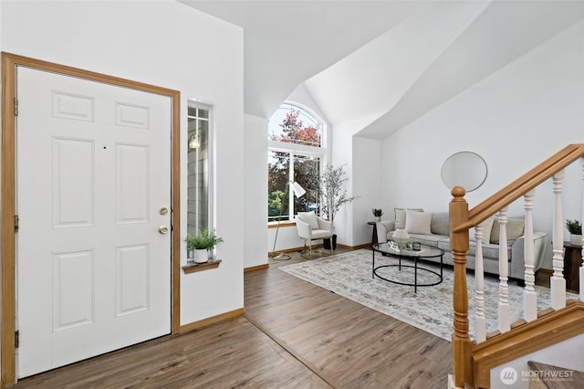 21012 82nd St E, Bonney Lake, WA 98391 - entryway featuring wood finished floors, vaulted ceiling, and stairs