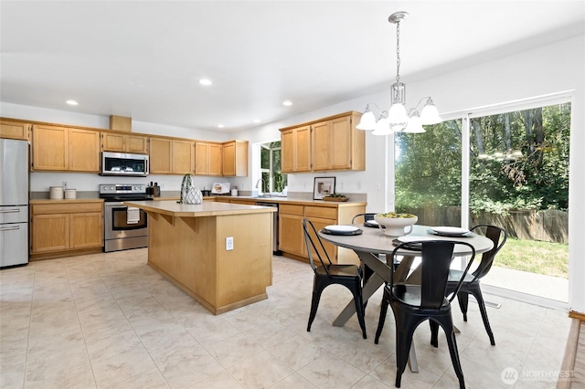 21012 82nd St E, Bonney Lake, WA 98391 - kitchen featuring appliances with stainless steel finishes, a chandelier, light countertops, a kitchen island, and recessed lighting