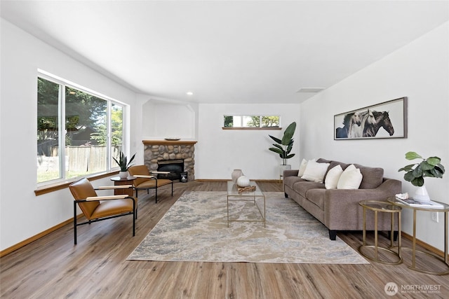 21012 82nd St E, Bonney Lake, WA 98391 - living area with plenty of natural light, a stone fireplace, and wood finished floors