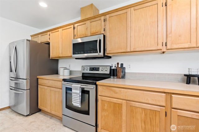 21012 82nd St E, Bonney Lake, WA 98391 - kitchen featuring appliances with stainless steel finishes, light brown cabinets, light countertops, light tile patterned flooring, and recessed lighting