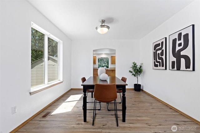 21012 82nd St E, Bonney Lake, WA 98391 - dining area featuring arched walkways and light wood finished floors