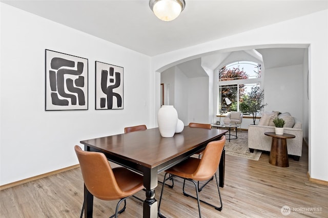 21012 82nd St E, Bonney Lake, WA 98391 - dining room with arched walkways, light wood-type flooring, and vaulted ceiling