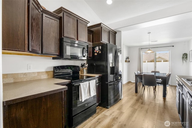 1344 E Deborah St, Moses Lake, WA 98837 - kitchen featuring black appliances, dark brown cabinets, light wood-style flooring, pendant lighting, and light countertops