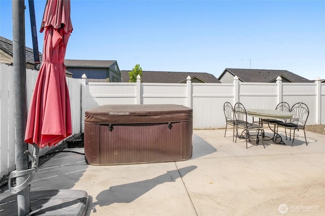 1344 E Deborah St, Moses Lake, WA 98837 - fenced backyard featuring a hot tub, a patio area, and outdoor dining space