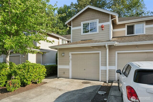 15150 140th Way SE Unit K103, Renton, WA 98058 - multi unit property featuring a garage, roof with shingles, and concrete driveway