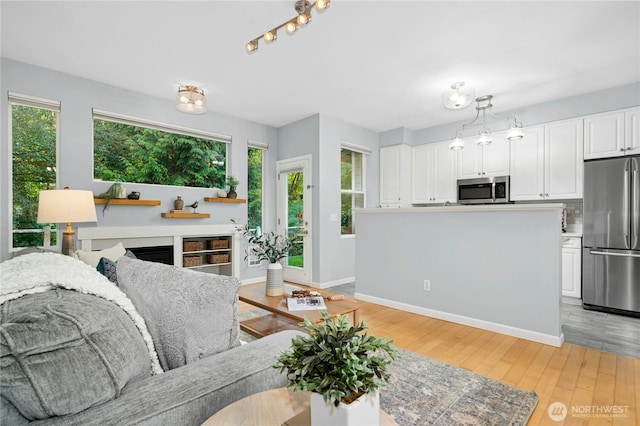 15150 140th Way SE Unit K103, Renton, WA 98058 - living room with light wood-style flooring and baseboards