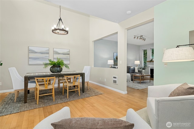 15150 140th Way SE Unit K103, Renton, WA 98058 - dining room with wood finished floors and a chandelier