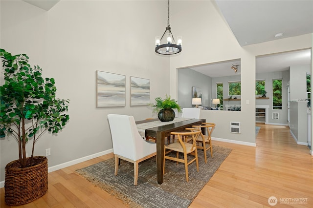 15150 140th Way SE Unit K103, Renton, WA 98058 - dining area with a chandelier, light wood-style floors, and a high ceiling