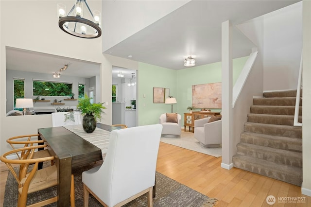 15150 140th Way SE Unit K103, Renton, WA 98058 - dining space featuring a chandelier, wood finished floors, and stairway