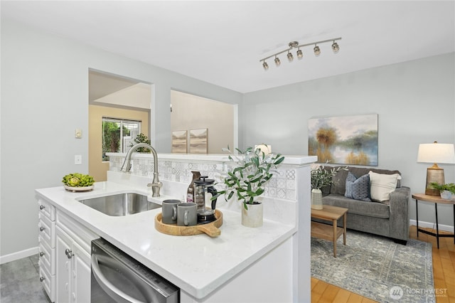 15150 140th Way SE Unit K103, Renton, WA 98058 - kitchen featuring dishwasher, white cabinetry, light countertops, light wood-type flooring, and open floor plan
