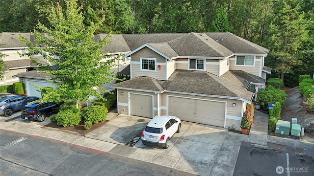 15150 140th Way SE Unit K103, Renton, WA 98058 - view of front of house featuring concrete driveway, a garage, and roof with shingles
