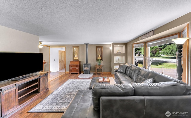 5215 Richmond Cres, Blaine, WA 98230 - living area with a textured ceiling, a wood stove, and wood finished floors