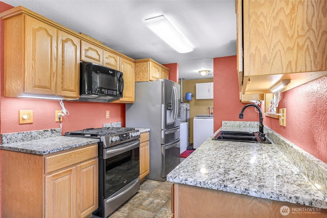 5215 Richmond Cres, Blaine, WA 98230 - kitchen featuring appliances with stainless steel finishes, washer / dryer, and light stone finish floors