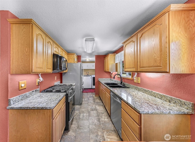 5215 Richmond Cres, Blaine, WA 98230 - kitchen with appliances with stainless steel finishes, washing machine and dryer, stone finish flooring, light stone countertops, and a textured ceiling
