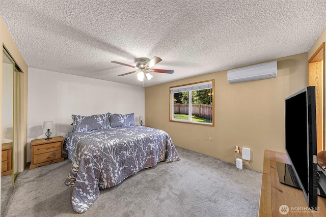 5215 Richmond Cres, Blaine, WA 98230 - carpeted bedroom featuring a wall mounted AC, ceiling fan, a closet, and a textured ceiling