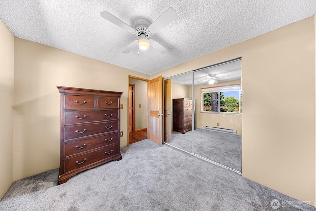 5215 Richmond Cres, Blaine, WA 98230 - bedroom featuring a baseboard radiator, light carpet, a closet, a textured ceiling, and a ceiling fan