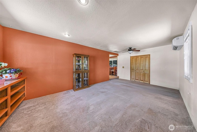 5215 Richmond Cres, Blaine, WA 98230 - spare room featuring a wall mounted AC, a ceiling fan, a textured ceiling, and carpet flooring