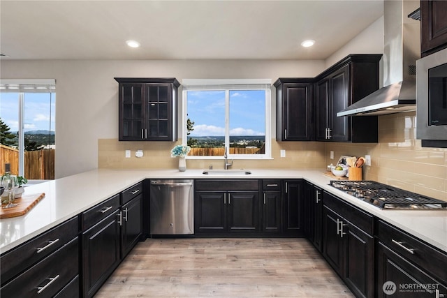 6639 S 298th Pl, Auburn, WA 98001 - kitchen featuring stainless steel appliances, wall chimney range hood, light wood finished floors, light countertops, and recessed lighting