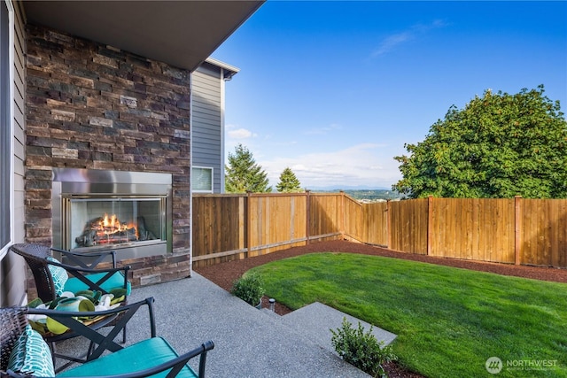 6639 S 298th Pl, Auburn, WA 98001 - fenced backyard with an outdoor stone fireplace and a patio