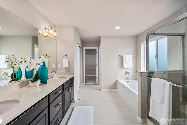6639 S 298th Pl, Auburn, WA 98001 - full bathroom with double vanity, a bath, a stall shower, a walk in closet, and recessed lighting