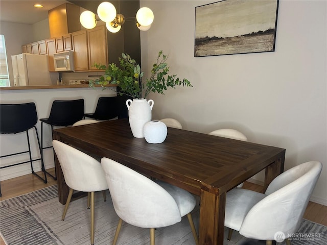 21507 42nd Ave S Unit P3, Seatac, WA 98198 - dining area with light wood-type flooring and baseboards