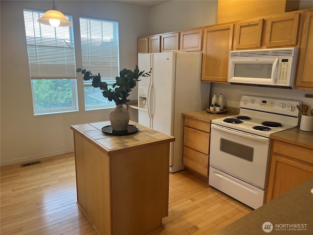 21507 42nd Ave S Unit P3, Seatac, WA 98198 - kitchen featuring white appliances, tile countertops, light wood finished floors, and pendant lighting