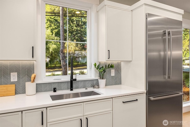 10511 NE 112th St, Kirkland, WA 98033 - kitchen featuring stainless steel built in refrigerator, tasteful backsplash, light countertops, and white cabinets
