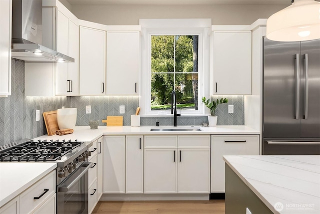 10511 NE 112th St, Kirkland, WA 98033 - kitchen with premium appliances, wall chimney exhaust hood, white cabinets, and tasteful backsplash